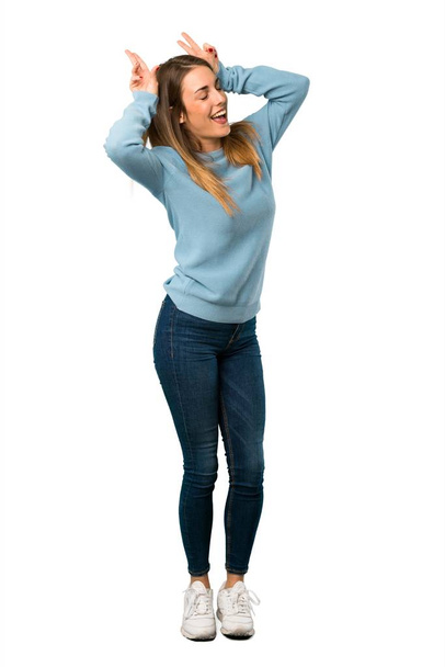 Full body of Blonde woman with blue shirt makes funny and crazy face emotion on white background - Foto, Imagem