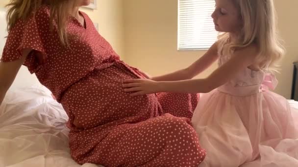 Young  Pregnant Mother  Playing with her Little Funny Daughter While Sitting on a  Sofa - Filmagem, Vídeo