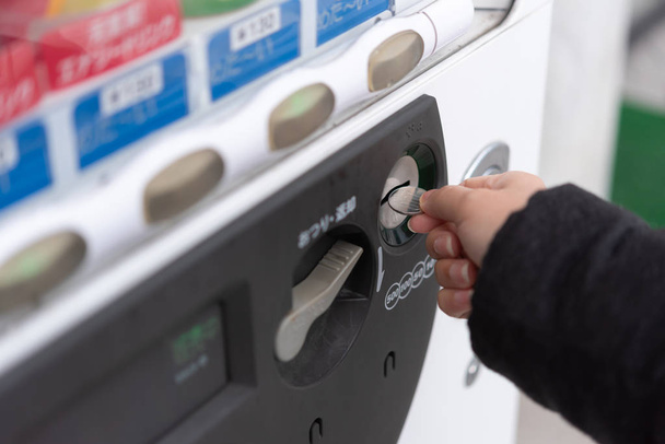asiatische Reisende wählen Produkt aus Automaten im Winter Japan. - Foto, Bild