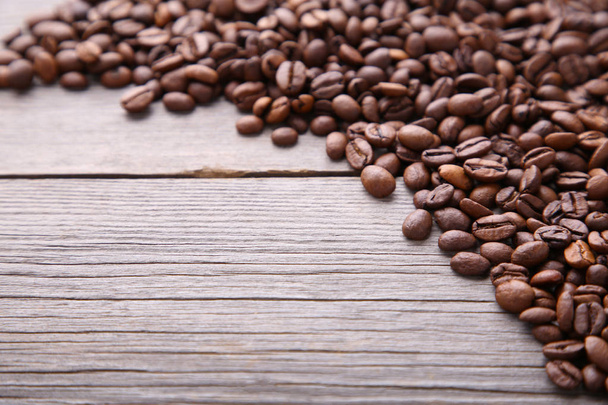 Coffee beans on grey wooden background - Фото, изображение