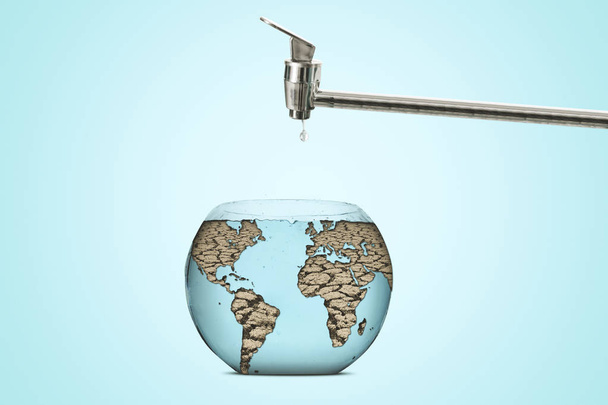 Close up of a dry earth globe shaped an aquarium bowl with faucet, Concept of global warming - Фото, зображення