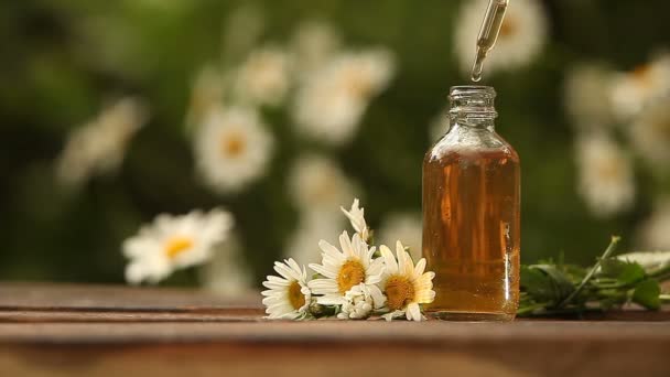 Essence of flowers on table in beautiful glass bottle - Footage, Video