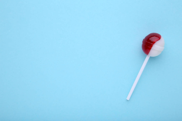Candy lollipop on a blue background. - 写真・画像