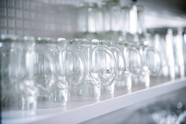 empty beer glasses on the shelf - 写真・画像