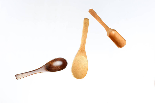 Wooden spoon utensils on white background elevated flying floating  - 写真・画像