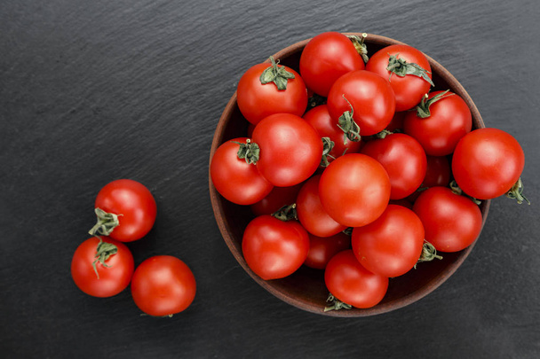 ripe red tomatoes laid out on a black background. space for tex - Photo, image