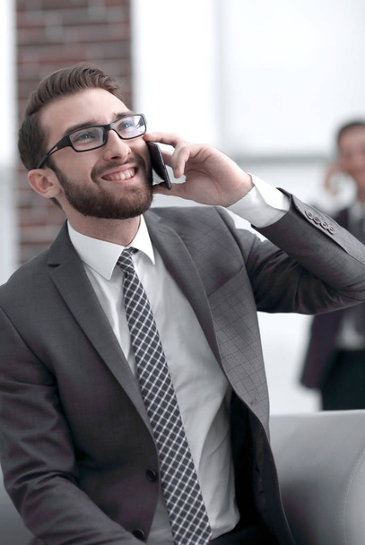 Charming businessman talking on phone  in a modern building - Zdjęcie, obraz