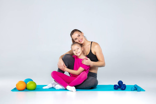 Sportive woman and 10 years old girl with slamballs - Photo, Image