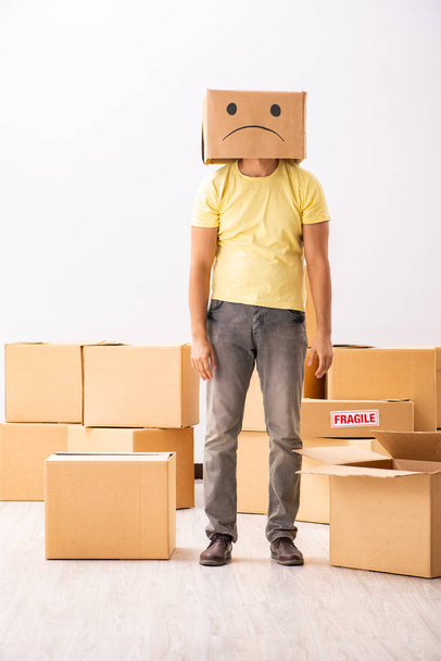 Unhappy man with box instead of his head - Photo, Image