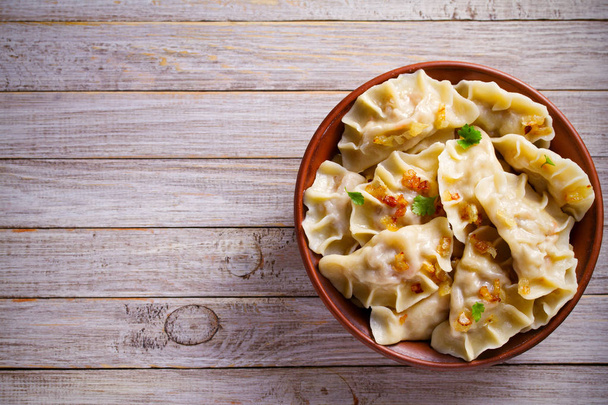 Dumplings, filled with cabbage. Varenyky, vareniki, pierogi, pyrohy - dumplings with filling. overhead, horizontal, room for text, copy space - 写真・画像