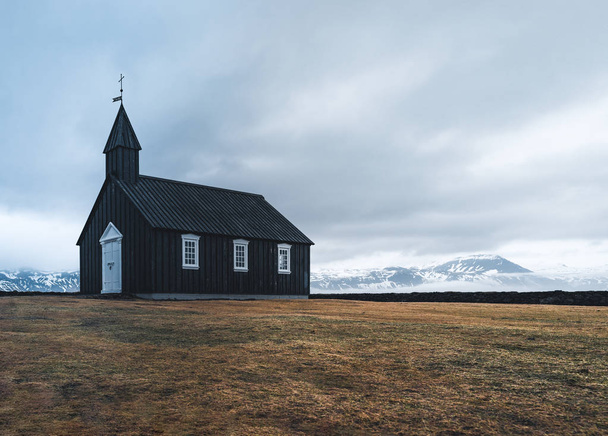 Famous picturesque black church of Budir at Snaefellsnes peninsula region in Iceland during a heavy snowy weather - 写真・画像