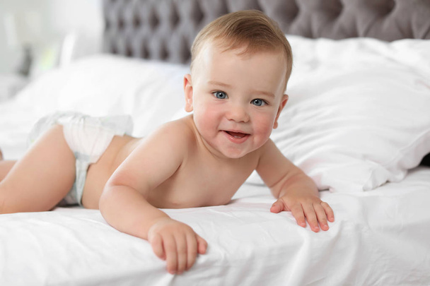 Adorable little baby with allergy lying on bed at home - Foto, imagen