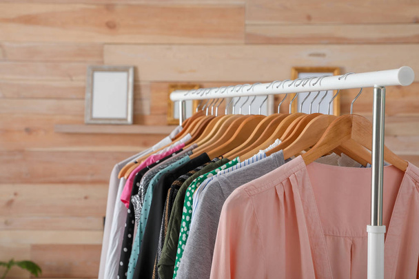 Wardrobe rack with stylish female clothes indoors, space for text - Valokuva, kuva