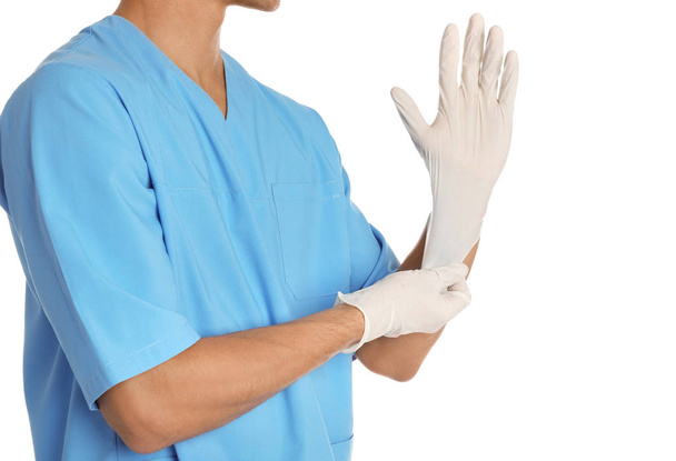 Male doctor putting on rubber gloves against white background. Medical object - Foto, Imagem