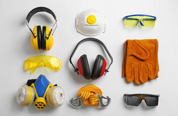 Flat lay composition with safety equipment on white background - Fotografie, Obrázek