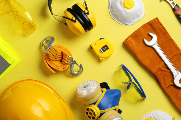 Flat lay composition with safety equipment on color background - 写真・画像