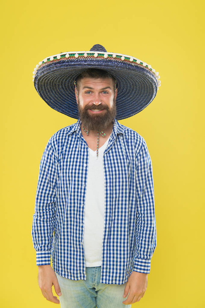 A crazy hat for crazy hat day. Mexican man wearing sombrero. Bearded man in mexican hat. Hipster in wide brim. Traditional fashion accessory for mexican costume party. Hes in love with mexican style - Foto, imagen