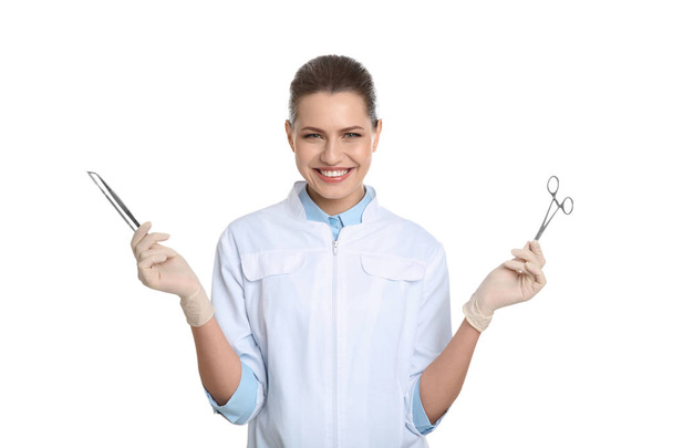 Female dentist holding professional tools on white background - Photo, Image