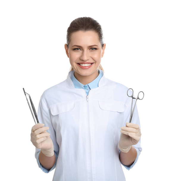 Female dentist holding professional tools on white background - Fotoğraf, Görsel