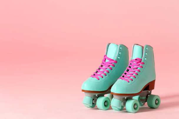 Pair of vintage roller skates on color background. Space for text - Φωτογραφία, εικόνα