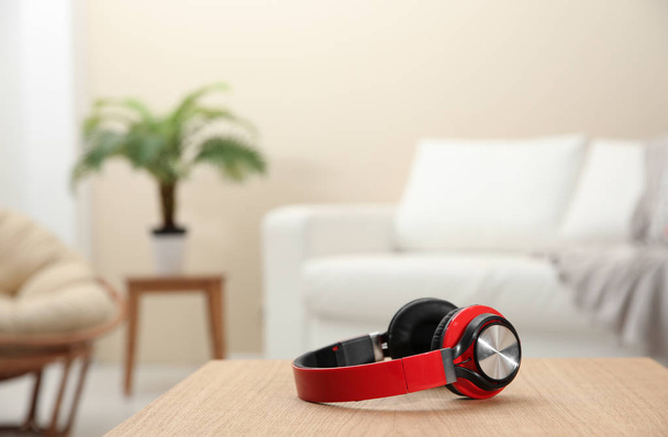 Stylish headphones on table indoors. Space for text - Photo, image