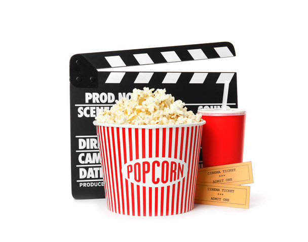 Popcorn bucket, clapper, drink and tickets isolated on white. Cinema snack - Foto, Imagen