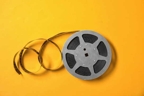 Movie reel on color background, top view. Cinema production - Фото, зображення