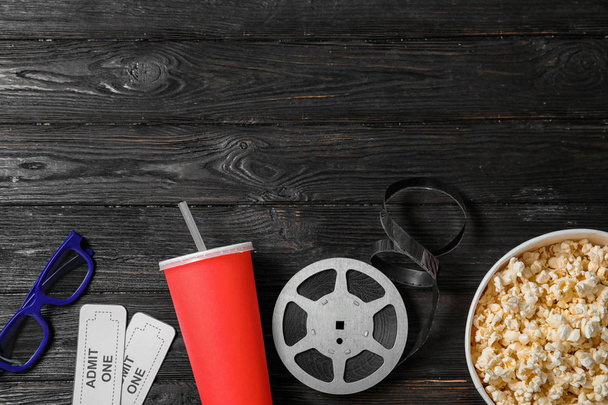 Flat lay composition with tickets, popcorn and space for text on wooden background. Cinema snack - Фото, изображение