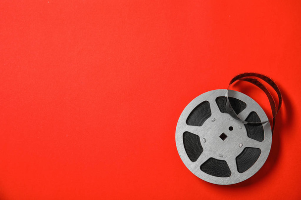Movie reel on color background, top view with space for text. Cinema production - Photo, image