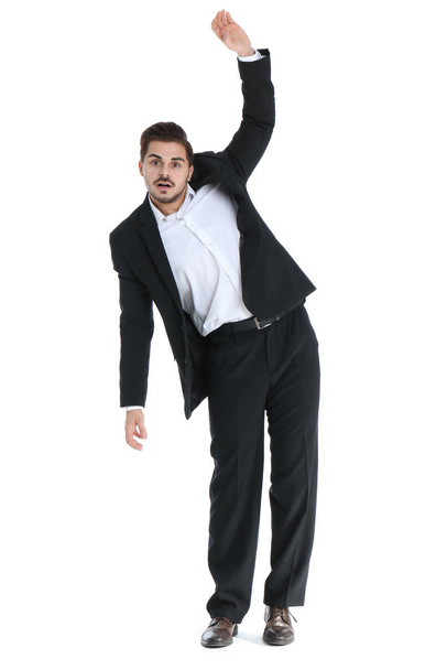 Young businessman attracted to magnet on white background - Foto, Imagem
