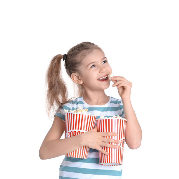 Cute little girl with popcorn on white background - Fotoğraf, Görsel