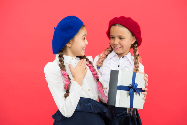 Girl giving gift box to friend. Girls friends celebrate holiday. Children formal wear with gift box. Open gift now. Friendship concept. Birthday present. Shopping and holidays. For my dear friend - Foto, imagen