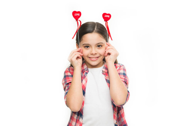 Making your heart melt for her. Small girl holding hearts on sticks. Funny girl with small red hearts. Small child with heart shaped decorations. Happy valentines day. The holiday of love and romance - 写真・画像