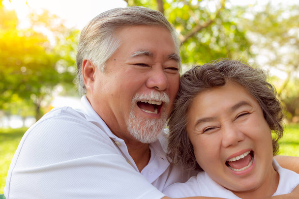 Happy life and long lived concept. Attractive handsome old man and charming beautiful old woman are laughing funny stories together and get relaxing. Grandmother and grandfather have good health - Photo, Image