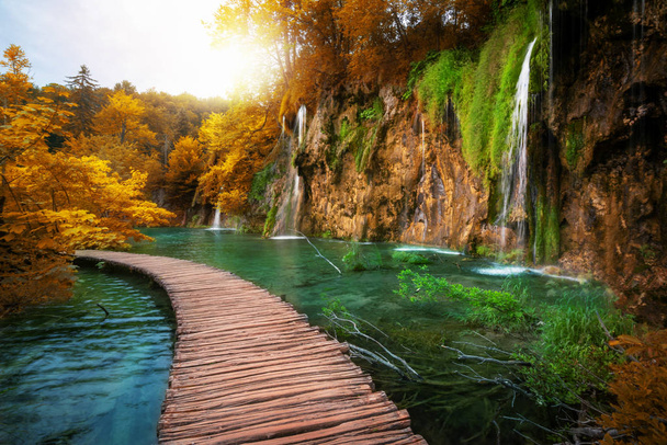 Beautiful wooden path trail for nature trekking with lakes and waterfall landscape in Plitvice Lakes National Park, UNESCO natural world heritage and famous travel destination of Croatia. - Photo, Image