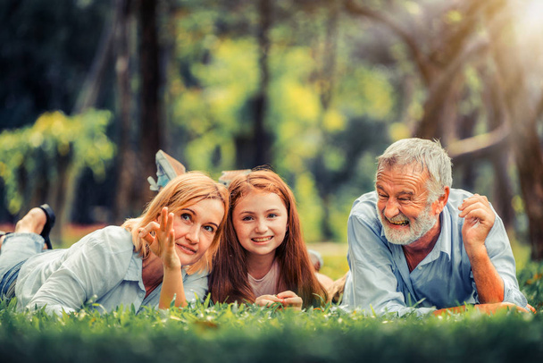 Happy family relaxing together in the park in summer. Concept of family bonding and relationship. - Foto, immagini