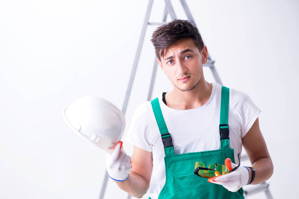 Young worker with protective equipment in safety concept - Photo, Image