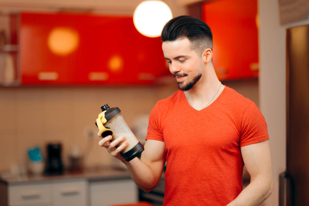 Fit Healthy Man Drinking a Protein Shake in the Kitchen - Photo, image