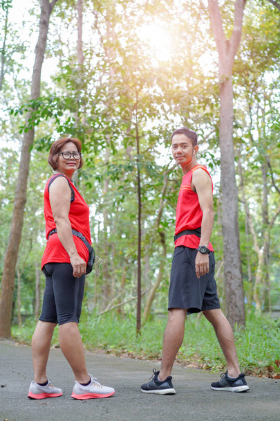 Happy asian mother and son jogging running in the park, Elderly care exercise sport activity concept  - Photo, Image