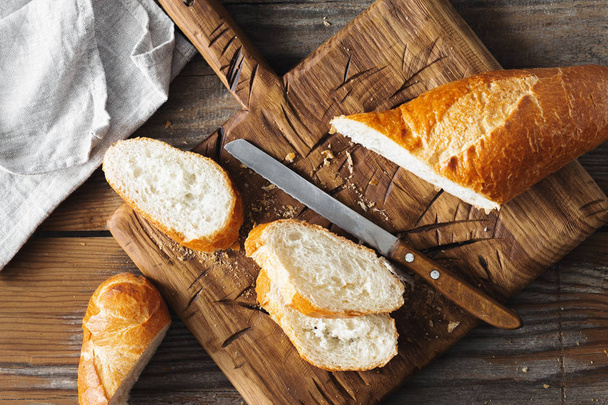 Sliced French Baguette Bread On Wooden Table In The Bakery - Fotoğraf, Görsel