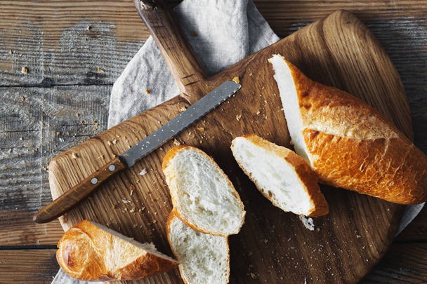 Sliced French Baguette Bread On Bread Board In The Bakery - Foto, Imagen