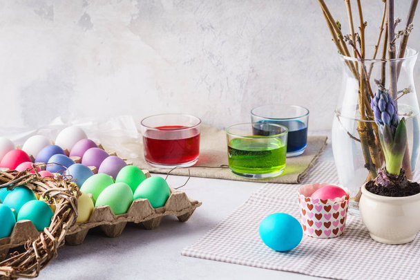 Painting eggs for Easter. Colorful eggs, paints and festive decoration. Spring holidays preparation concept. Copy space. - Photo, image