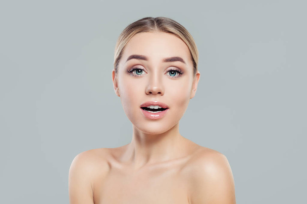 Young woman with healthy skin. Surprised girl. Facial treatment and skincare concept - Foto, Imagem