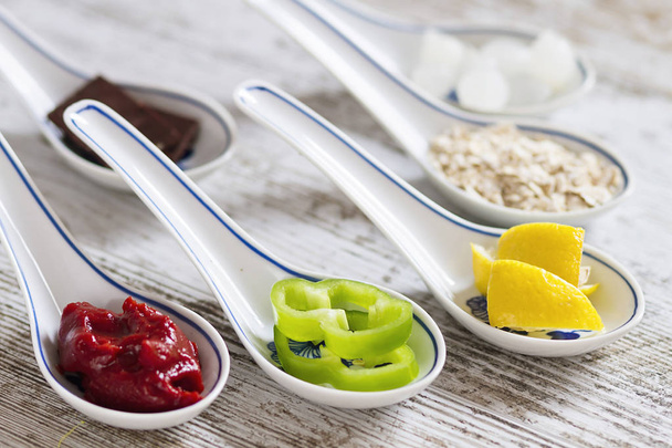 Porcelain spoons with cooking ingredients - Photo, Image