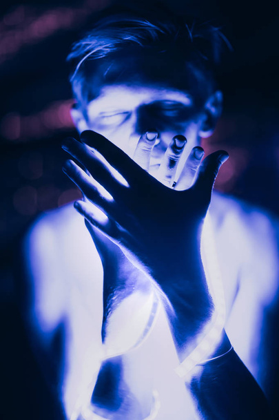 Portrait man Strip Light LED tape on dark color background. - Fotó, kép