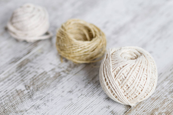 Natural fiber rope balls over a wooden background - Фото, зображення