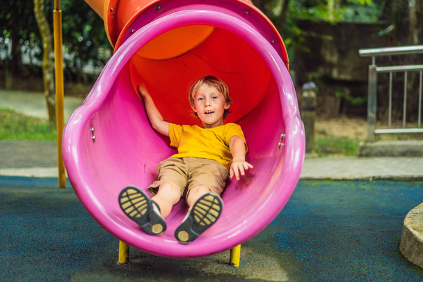 Funny cute happy baby playing on the playground. The emotion of happiness, fun, joy - Φωτογραφία, εικόνα
