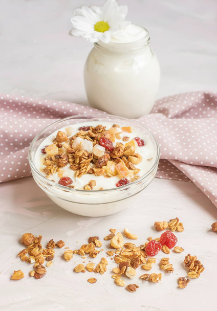 Natural yoghurt with granola nuts and dried fruits. natural healthy food. - Fotoğraf, Görsel
