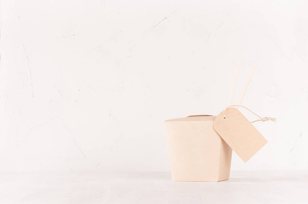 Blank brown paper noodles box for food takeaway and label on soft light white background, mockup for brand, design, advertising. - Fotó, kép
