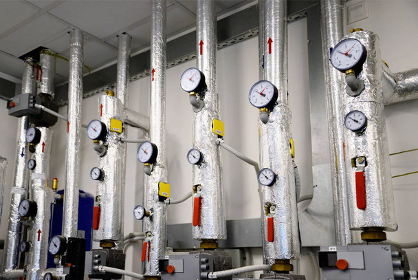 Fermeture des tuyaux et des termomètres du système de chauffage. Pipelines argentées. Concept industriel
. - Photo, image